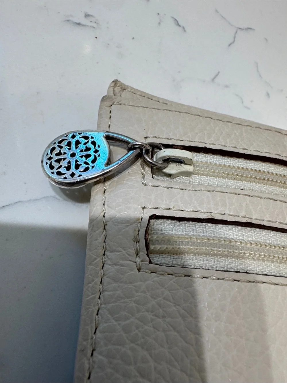 Brighton Cream Pebbled Leather Ferrara Fold Wallet with Embossed Medallion